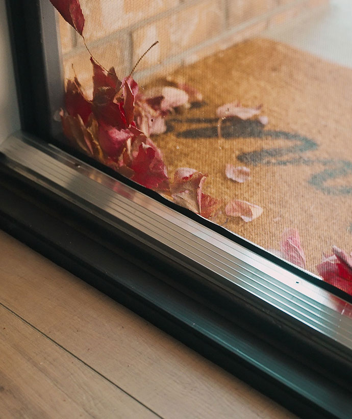Close-up of mesh screen edge showing secure zipper track system for pet protection