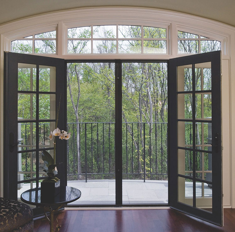 French doors open to a wooded view with a retractable screen across the center, blending subtly into the doorway.