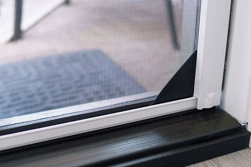A home door screen reinforced with mesh lock for stability and durability and to keep small pets in.