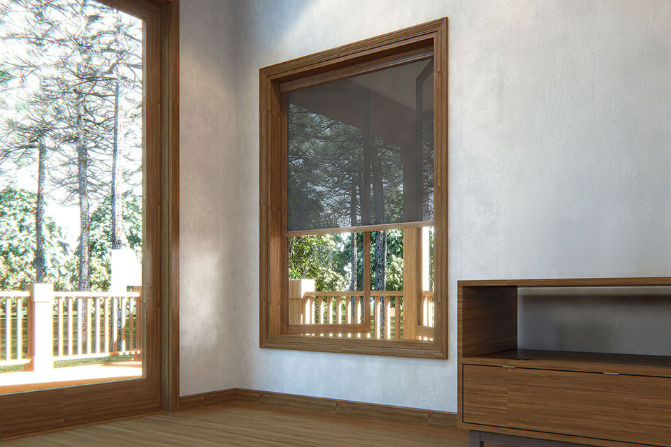 Bright room with wood-framed window and retractable screen, showcasing forest views through deck railing.